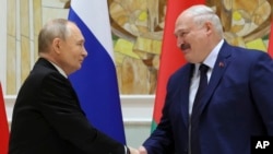 Russian President Vladimir Putin and Belarusian President Alexander Lukashenko shake hands during a ceremony in Minsk, Belarus, on Dec. 6, 2024.