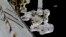 In this frame from NASA TV, astronauts Mark Vande Hei and Randy Bresnik, bottom, work on the International Space Station, Oct. 5, 2017.