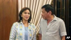 FILE - In this photo provided by the Office of the Vice-president (OVP), Philippines President Rodrigo Duterte meets with Vice President Leni Robredo during the latter's courtesy call at Malacanang Palace.