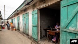 A man works in a shop while others are closed at the Ajara Market due to low sales in Badagry, near Lagos, Sept. 6, 2019. A wave of kidnappings in Nigeria is being blamed largely on economic hardship.