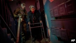 An elderly resident is evacuated from the southern city of Kherson, Ukraine, Nov. 27, 2022.