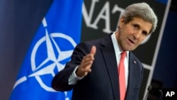U.S. Secretary of State John Kerry speaks during a media conference after a meeting NATO foreign ministers at NATO headquarters in Brussels, Dec. 3, 2013.