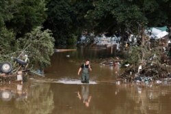 A man walks through floodwater following heavy rain in Bad Neuenahr-Ahrweiler, Germany, July 15, 2021.