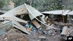 Houses are seen damaged from the eruption of Mount Lewotobi Laki-Laki in East Flores, Indonesia, Nov. 4, 2024. 