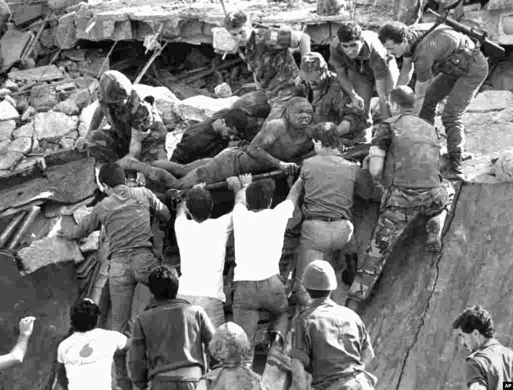 FILE - British soldiers help in rescue operations at the site of the bomb-wrecked U.S. Marine command center near the Beirut airport, Lebanon, Oct. 23, 1983. 