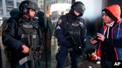 A pedestrian asks directions from two heavily armed counterterrorism officers stationed in Times Square, Thursday, Dec. 29, 2016, in New York. 
