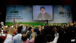 Hezbollah leader Sheikh Hassan Nasrallah speaks via a video link during a graduation ceremony in a southern suburb of Beirut, Lebanon, July 25, 2015.