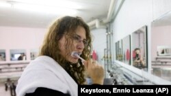File: Liv Peters from Sennwald brushes her teeth in the washing room of the Zero Star Hotel in Sevelen, Switzerland, Saturday, Nov. 15, 2008