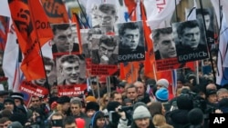 Warga Rusia melakukan pawai untuk mengenang pemimpin oposisi Boris Nemtsov, yang ditembak mati pada hari Jumat, 27 Februari 2015 dekat Kremlin di Moskow, Rusia, Minggu, 1 Maret 2015. (AP Photo/Dmitry Lovetsky)