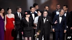 The cast and crew of "The Marvelous Mrs. Maisel" accept the award for outstanding comedy series at the 70th Primetime Emmy Awards on Monday, Sept. 17, 2018, at the Microsoft Theater in Los Angeles, California. 