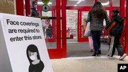 An information sign is displayed at a retail store in Niles, Ill., Dec. 18, 2021. 