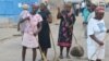 FILE - A group of women sweep a main street in the fishing village of Cotes-de-Fer, Haiti, Oct. 25, 2014.