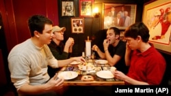 Will Foster, Jr. and three other Birmingham-Southern College students try the food at Dreamland Bar-B-Que in Tuscaloosa, Alabama as part of an unusual writing class that combines eating barbeque with academics.