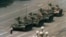 FILE - A Chinese man stands alone to block a line of tanks heading east on Beijing's Cangan Boulevard in Tiananmen Square, in early June 1989. 