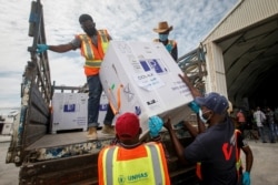FILE - Boxes of the AstraZeneca COVID-19 vaccine, manufactured by the Serum Institute of India and provided through the global COVAX initiative, arrive at the airport in Mogadishu, Somalia, March 15, 2021.