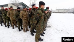 FILE - Soldiers are seen during then-German Minister of Defense Ursula von der Leyen's visit with German troops deployed as part of NATO enhanced Forward Presence (eFP) battle group in Rukla military base, Lithuania, Feb. 4, 2019.