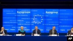 Activists wave an old Soviet and Russian national flags in front of a barricade at the regional administration building, in Donetsk, Ukraine.