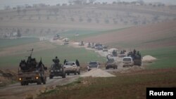 FILE - Members of al Qaida's Nusra Front drive in a convoy as they tour villages, which they said they have seized control of from Syrian rebel factions, Dec. 2, 2014.
