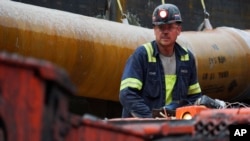 A miner runs a coal continuous miner at a coal mine in Friedens, Pennsylvania, June 7, 2017. 