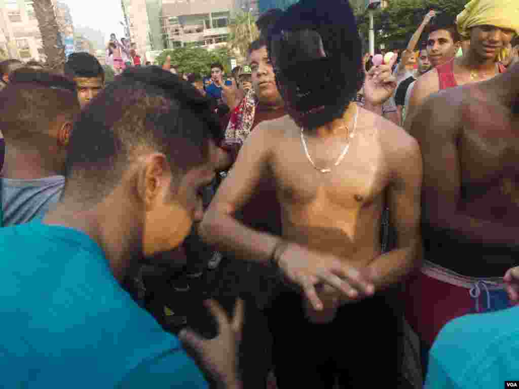 A young Egyptian man wearing a gorilla mask does the &ldquo;Shaby&rdquo; dance after Friday prayers, as a DJ starts the party, in Cairo, Egypt, July 6, 2016. (Photo: Hamada Elrasam for VOA)