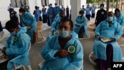 FILE - People with heart conditions, who recovered from COVID-19, prepare to go home during World Heart day celebrations at a government hospital in Chennai, Sept. 29, 2020. 
