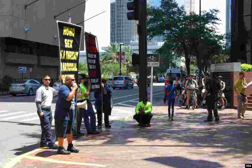 A group protesting the Mormon church outside the Republican National Convention, Tampa, Florida, August 28, 2012. (J. Featherly/VOA)