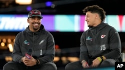 Kansas City Chiefs quarterback Patrick Mahomes, right, and Philadelphia Eagles quarterback Jalen Hurts speak to the media during the NFL football Super Bowl 57 opening night, Monday, February 6, 2023, in Phoenix, Arizona. (AP Photo/David J. Philip)