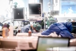 Medical personnel work in the intensive care unit of the hospital of Brescia, Italy, March 19, 2020. Italy has become the country with the most coronavirus-related deaths, surpassing China.