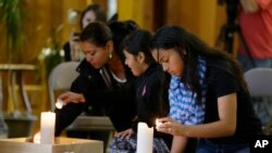 Guests light candles as they attend a prayer service, Sept. 24, 2016, at the Central United Methodist Church in Sedro-Woolley, Wash. 
