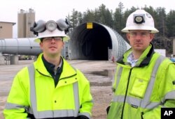 In this May 8, 2014 photo Eagle Mine advisors Dan Blondeau, left, and Andy Vaughn stand outside the mine's portal in Marquette, Mich. (AP Photo/John Flesher)