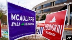 Spanduk kampanye untuk pemilihan calon Gubernur Virginia Terry McAuliffe (demokrat) dan Glenn Youngkin (Republik) pada hari terakhir pemungutan suara awal dalam pemilihan gubernur di Fairfax, Virginia, AS, 30 Oktober 2021. (REUTERS/Joshua Roberts)