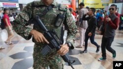 FILE - Malaysia military personnel patrol KL Sentral train station in Kuala Lumpur, Malaysia, July 7, 2016.