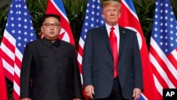 FILE - U.S. President Donald Trump, right, meets with North Korean leader Kim Jong Un on Sentosa Island, in Singapore, June. 12, 2018. 