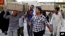 Bombing victims are taken for burial in the Sh'iite holy city of Najaf, Sept. 15, 2013.