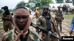 FILE - Seleka fighters stand in their base before a mission in the town of Lioto, Central African Republic, June 9, 2014.