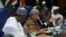 Nigeria's President Muhammadu Buhari, left, Liberia's President Ellen Johnson Sirleaf, center, and Marcel de Souza, president of the ECOWAS Commission, attend the Ordinary Session of the ECOWAS Heads of State and Government in Abuja, Nigeria, Dec. 17, 2016.