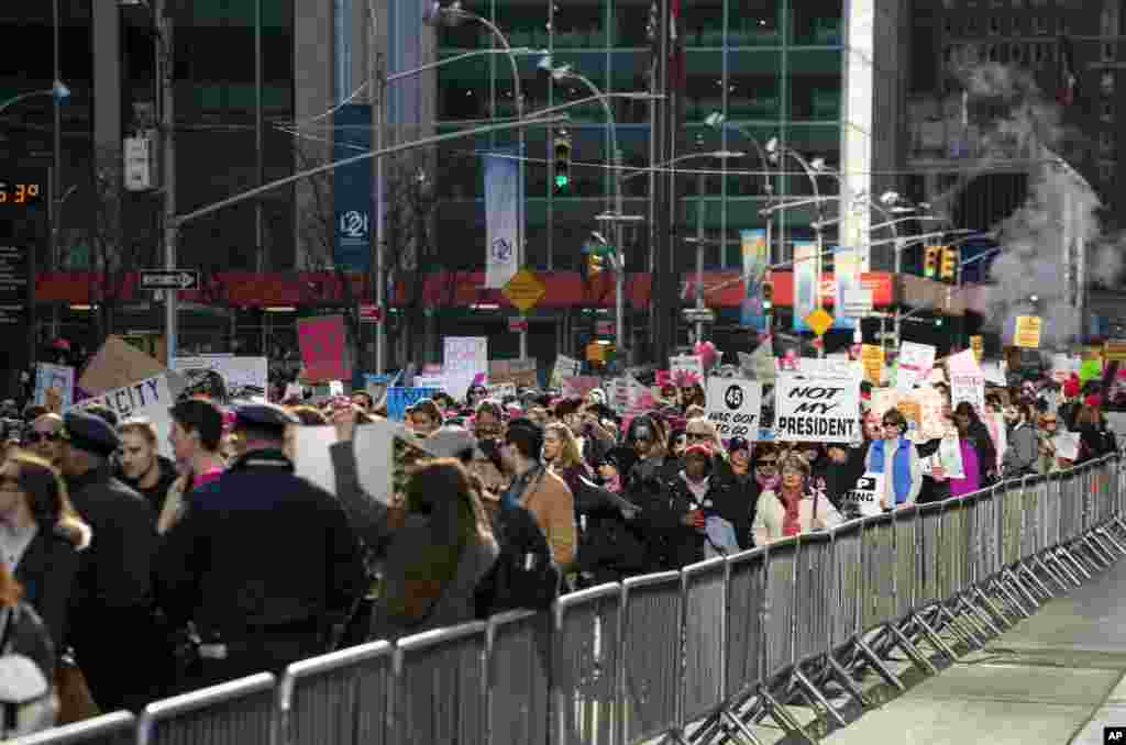 People taking part in a march highlighting equal rights and equality for women walk along Sixth Avenue in New York, Jan. 20, 2018. 