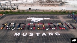 Photo provided by the Ford Motor Co., shows Mustang vehicles parked to spell out "10,000,000" on a parking lot at the Flat Rock Assembly plant, Aug. 8, in Flat Rock, Mich. 