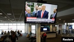 President Donald Trump is pictured on a television at Seattle-Tacoma International Airport as he declares a national emergency over the coronavirus, in SeaTac Washington, March 13, 2020. 