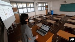 An unidentified teacher gives an online class amid the new coronavirus outbreak at Seoul girls' high school in Seoul, Thursday, April 9, 2020.