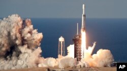  A SpaceX Falcon Heavy rocket carrying a communication satellite lifts off from pad 39A at the Kennedy Space Center in Cape Canaveral, Fla., April 11, 2019.