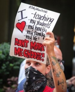 A coalition of teachers, students, and families protest during a rally called National Day of Resistance Against Unsafe School Reopening Opening, Aug. 3, 2020, in New York.