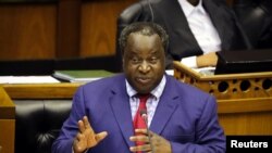 FILE - South African Finance Minister Tito Mboweni delivers his budget speech at Parliament in Cape Town, South Africa, Feb. 20, 2019. He was retained in President Cyril Ramaphosa's new cabinet.