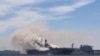 Smoke rises from a fire on board the U.S. Navy amphibious assault ship USS Bonhomme Richard at Naval Base San Diego, California, on July 12, 2020. Video of that fire has falsely been attributed to a Houthi attack in the Red Sea. 