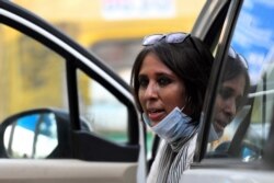 FILE - Journalist Barkha Dutt rests after reporting from Guru Teg Bahadur hospital in New Delhi, after authorities eased restrictions imposed as a preventive measure against the spread of the COVID-19 coronavirus, June 12, 2020.