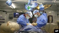 Some people who can't use parts of their bodies because of a spinal cord injury can still suffer from terrible pain in those same areas. A new treatment is helping them. (AP Photo)