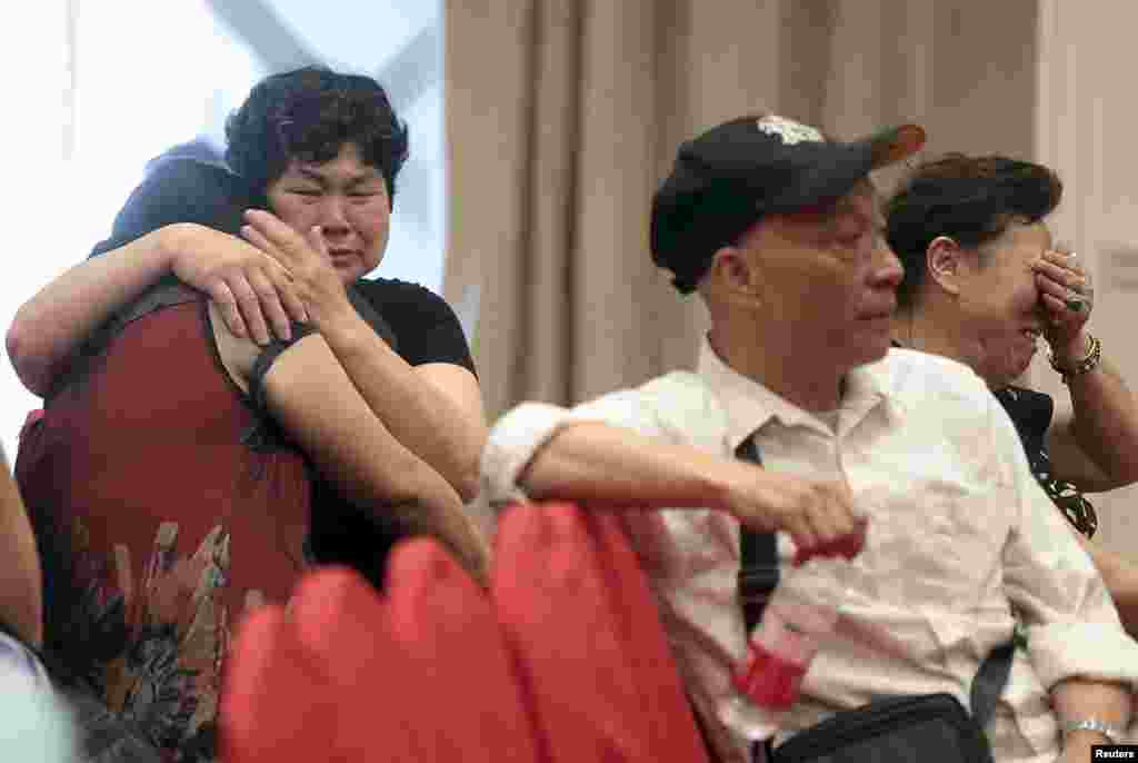 Relatives of passengers on the ship that sank at the Jianli section of Yangtze River in Hubei province, cry as they wait for news at a hotel, in Nanjing, Jiangsu province, China, June 2, 2015.