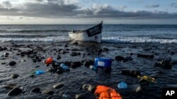 FILE - A wooden boat used by migrants from Morocco is seen at the coast of the Canary Islands, Oct. 16, 2020.