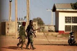 FILE - Military men walk inside the Government Science school in Kankara, in northwestern Katsina state, Nigeria, Dec. 13, 2020.