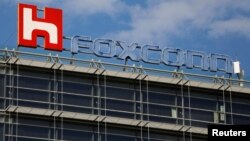 FILE - The logo of Foxconn, the trading name of Hon Hai Precision Industry, is seen on top of the company's building in Taipei, Taiwan.